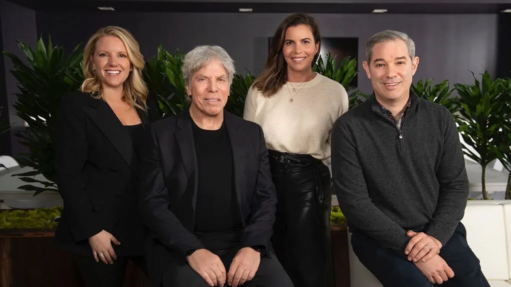 Ken Sunshine, Heather Lylis, Keleigh Thomas Morgan and Shawn Sachs standing together in an office