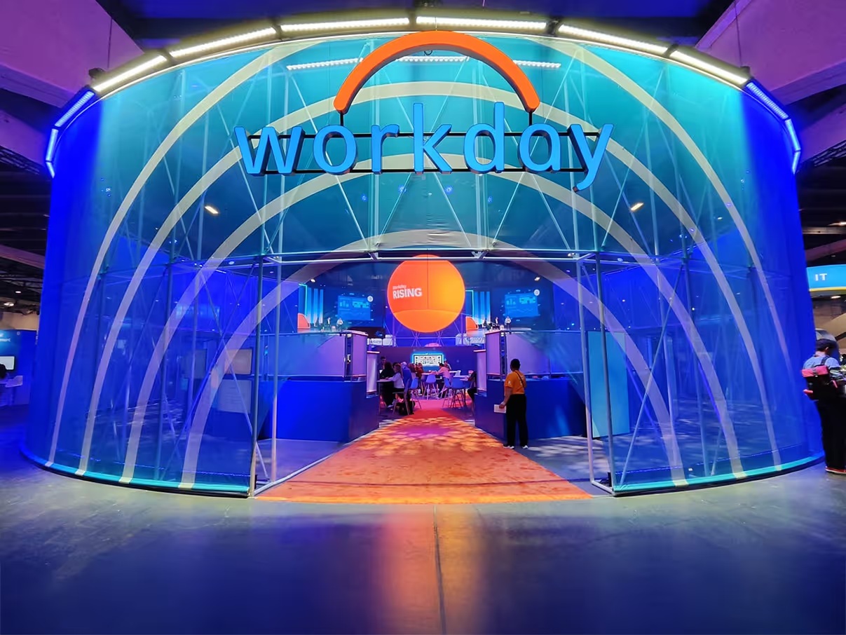 Curved blue Workday exhibition environment with an orange carpet leading through its entrance