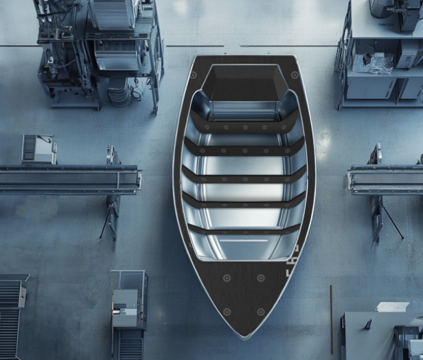 Overhead view of an aluminum boat hull on a factory floor