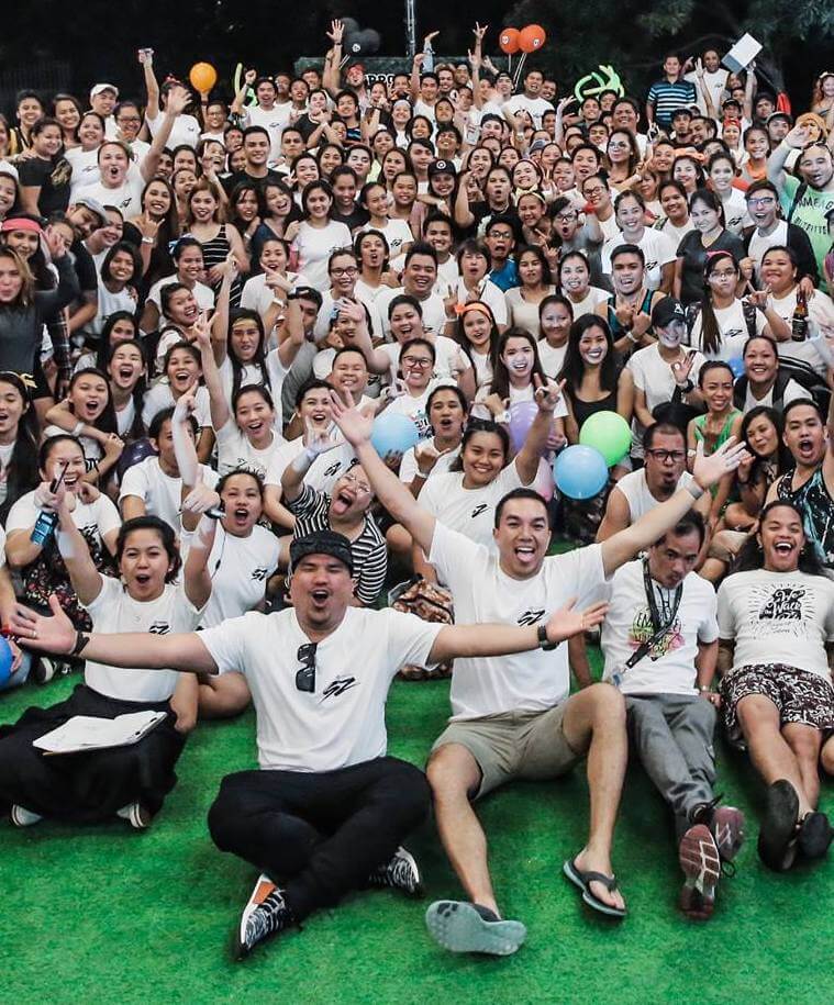 SupportZebra team members gathered together, waving and smiling