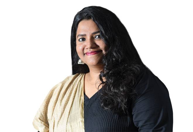 Surga Thilakan in a black outfit and cream shawl