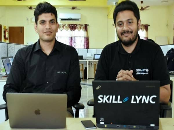 Surya, left, and Sarangarajan seated with laptops in the Skill-Lync office