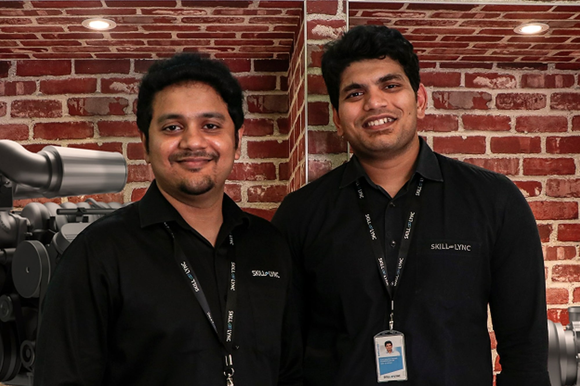Skill-Lync co-founders Sarangarajan V Iyengar, left, and Suryanarayanan Paneerselvam, right, beside an engine display