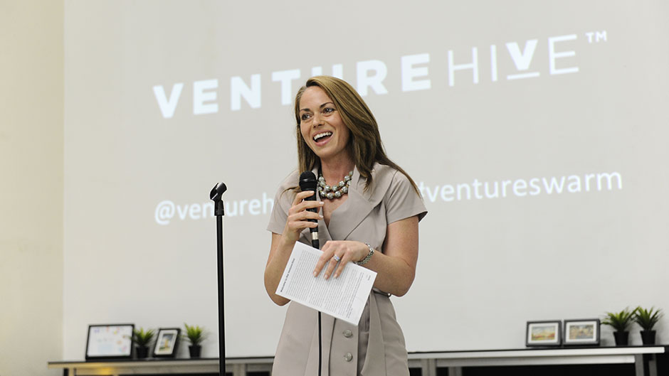 Susan Amat speaking into a microphone at a Venture Hive event