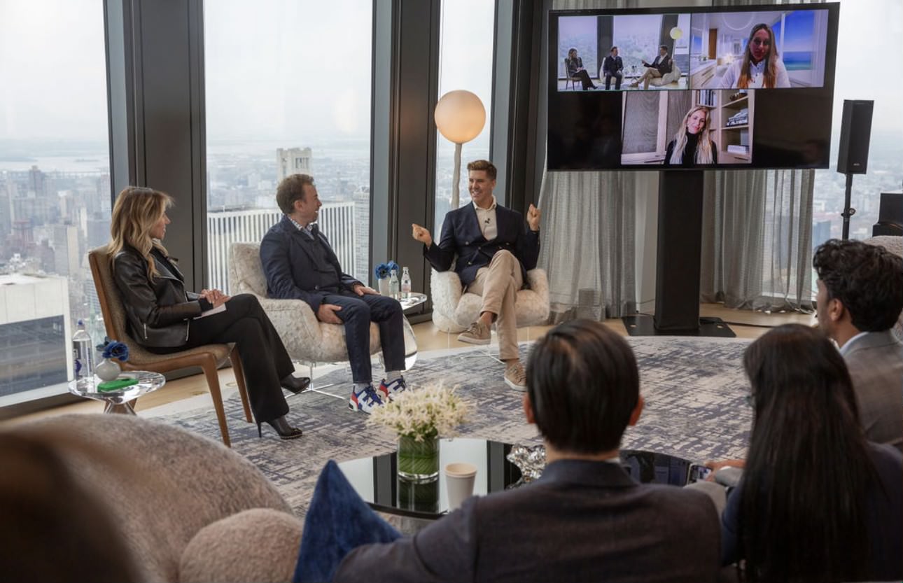 Susan de França, seated at left, moderates a design panel at 53 West 53 with participants in the room and on screen.