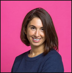 Susannah Vila smiling against a bright pink background