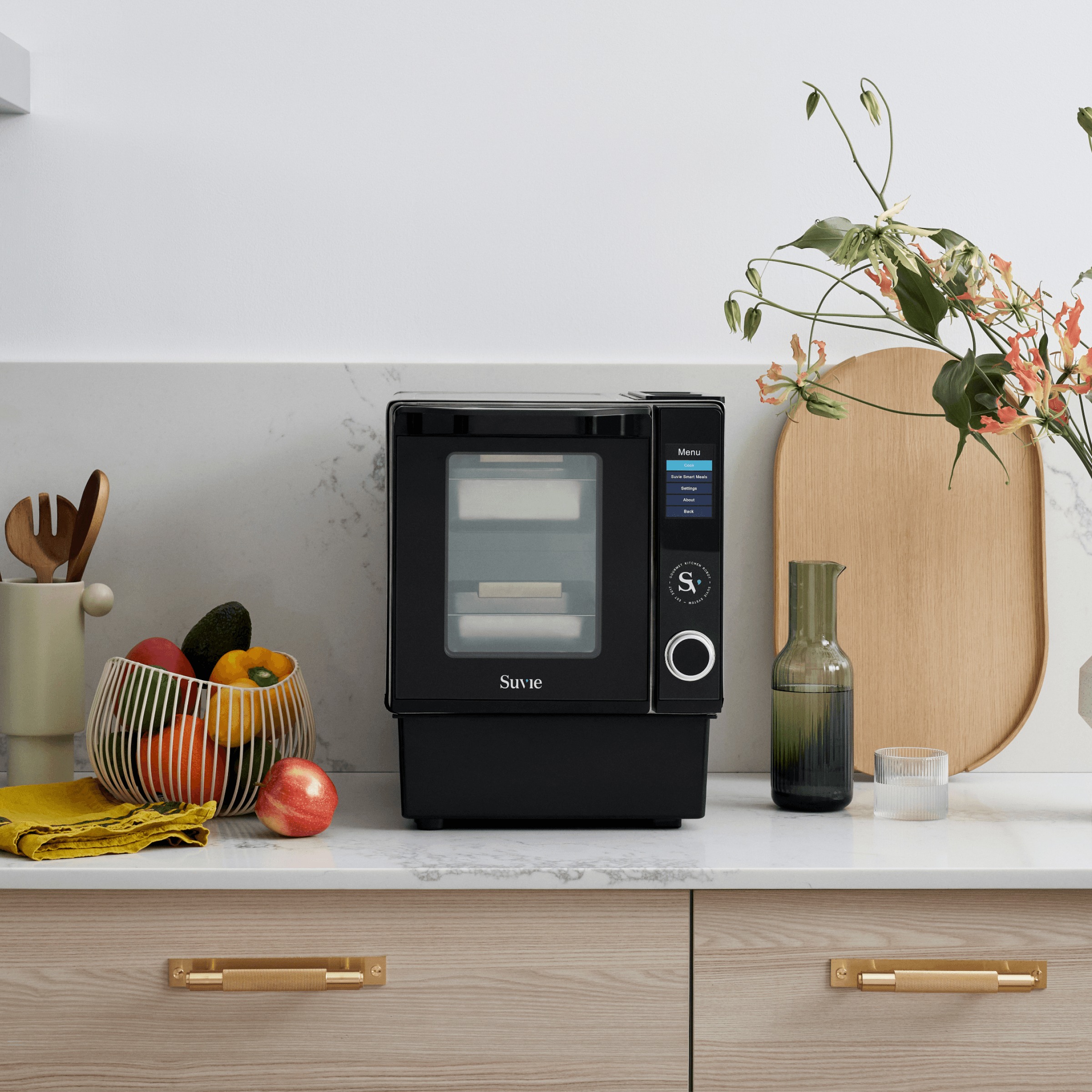 A current Suvie Kitchen Robot with two trays on a kitchen counter