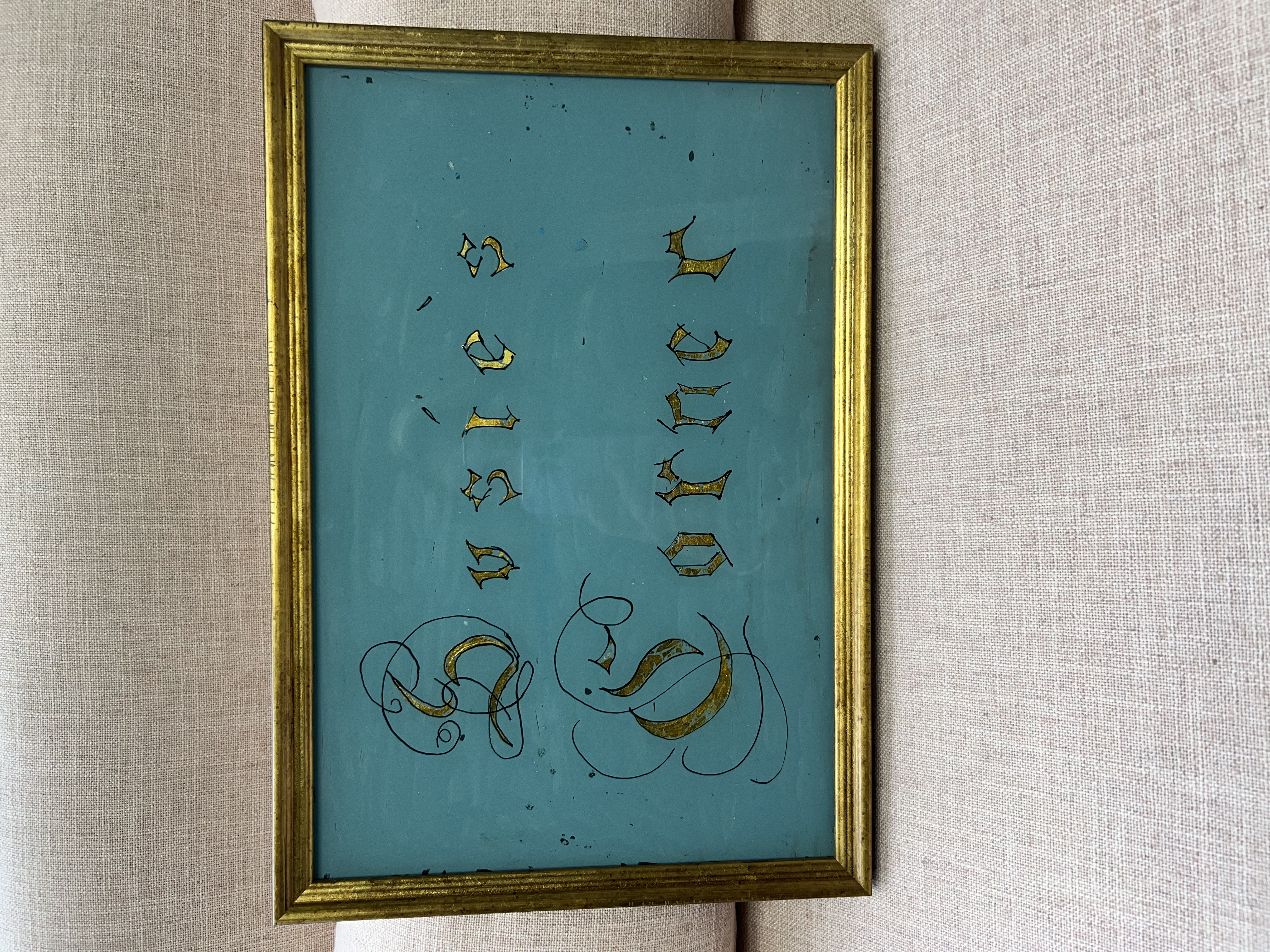 A turquoise and gold framed sign reading Suzie’s Corner