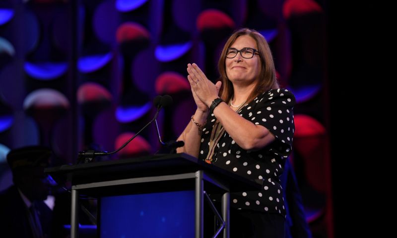 Suzy DePrizio applauds at a lectern during the American Legion national convention in Charlotte in 2023
