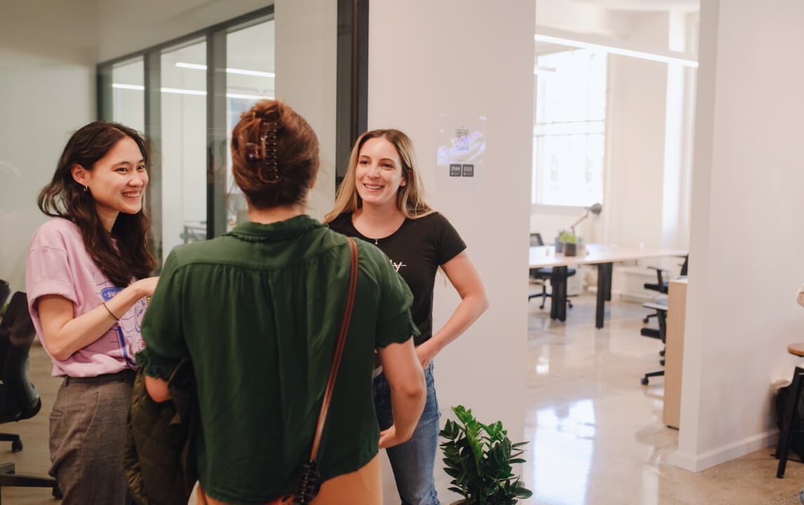 Swimm team members talking in a bright office