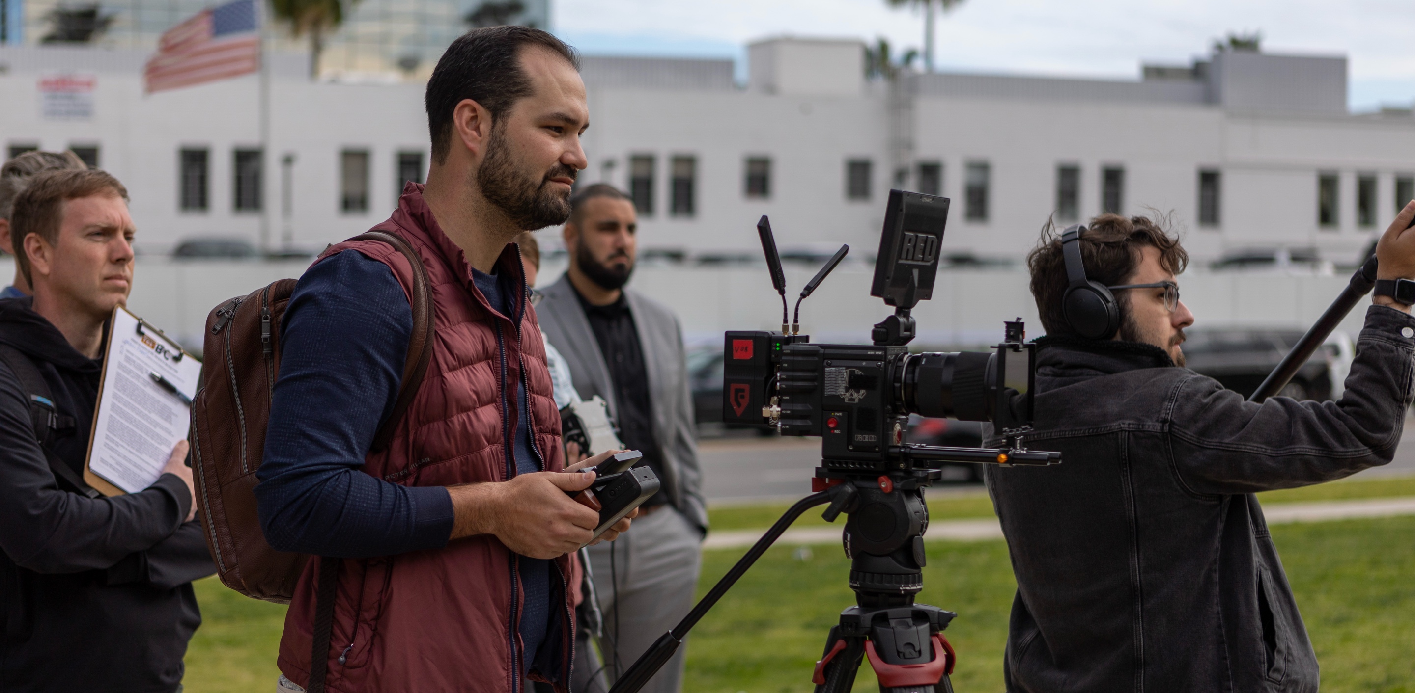 A production crew with a camera, sound equipment, and a clipboard in a photograph published by Swing Strategies