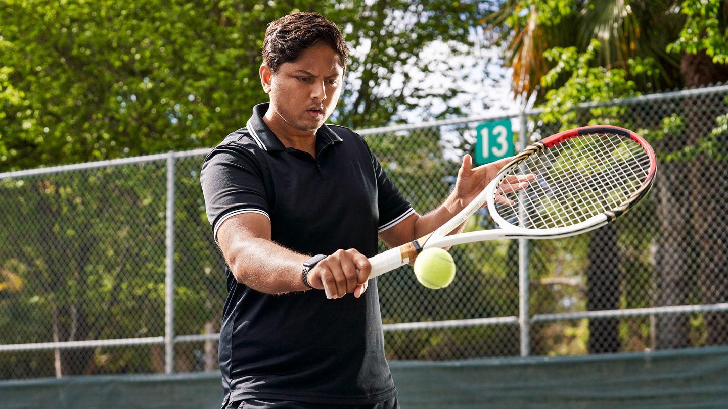 Swupnil Sahai playing a backhand on a tennis court