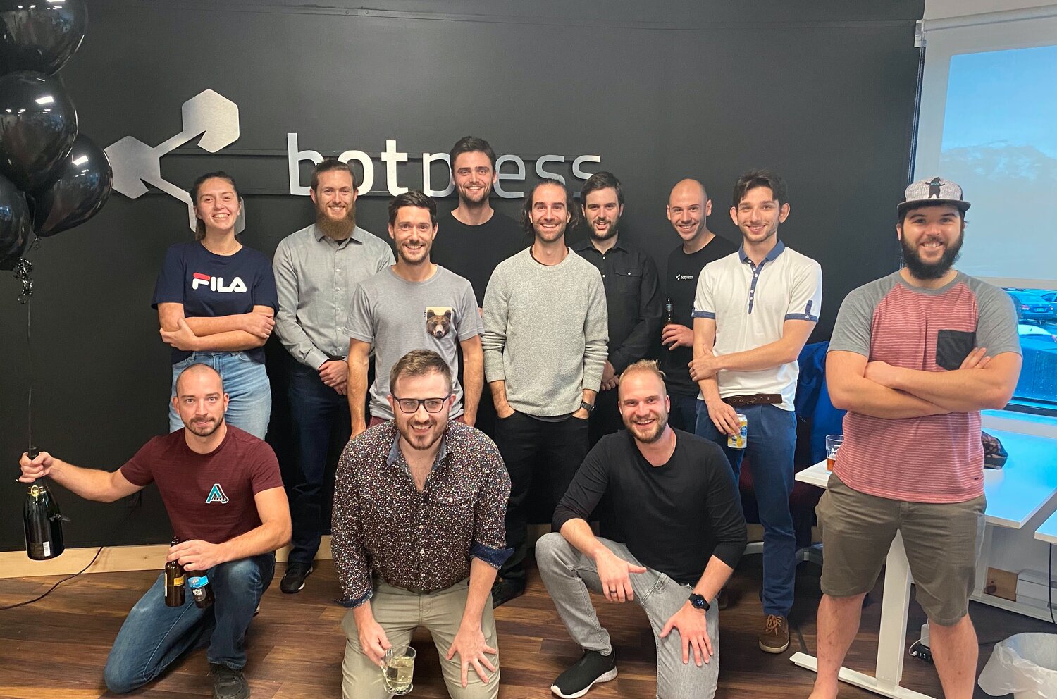 The Botpress team gathered in the office for a group photograph.