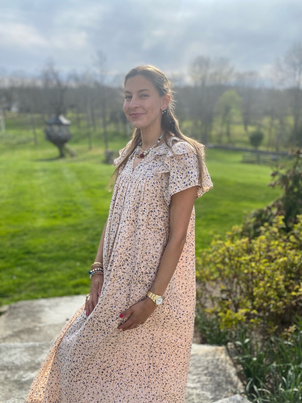 Sylvana Ward Durrett outdoors wearing a patterned dress in a country setting