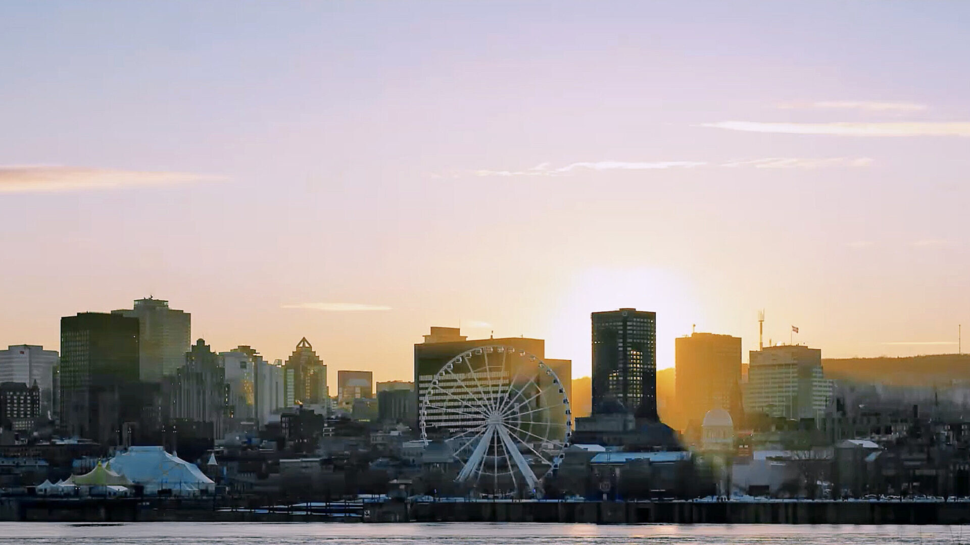 Montreal skyline at sunset with the Old Port observation wheel in the foreground