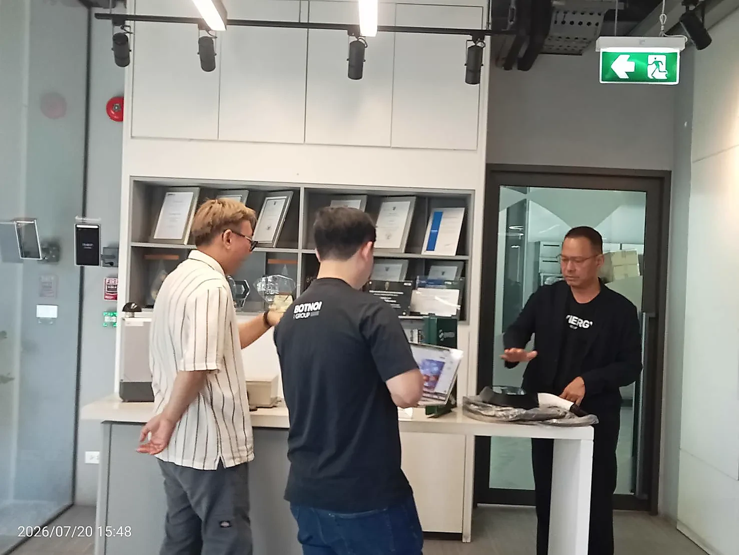 Synergy and Botnoi representatives discussing engineering during a July 2026 visit
