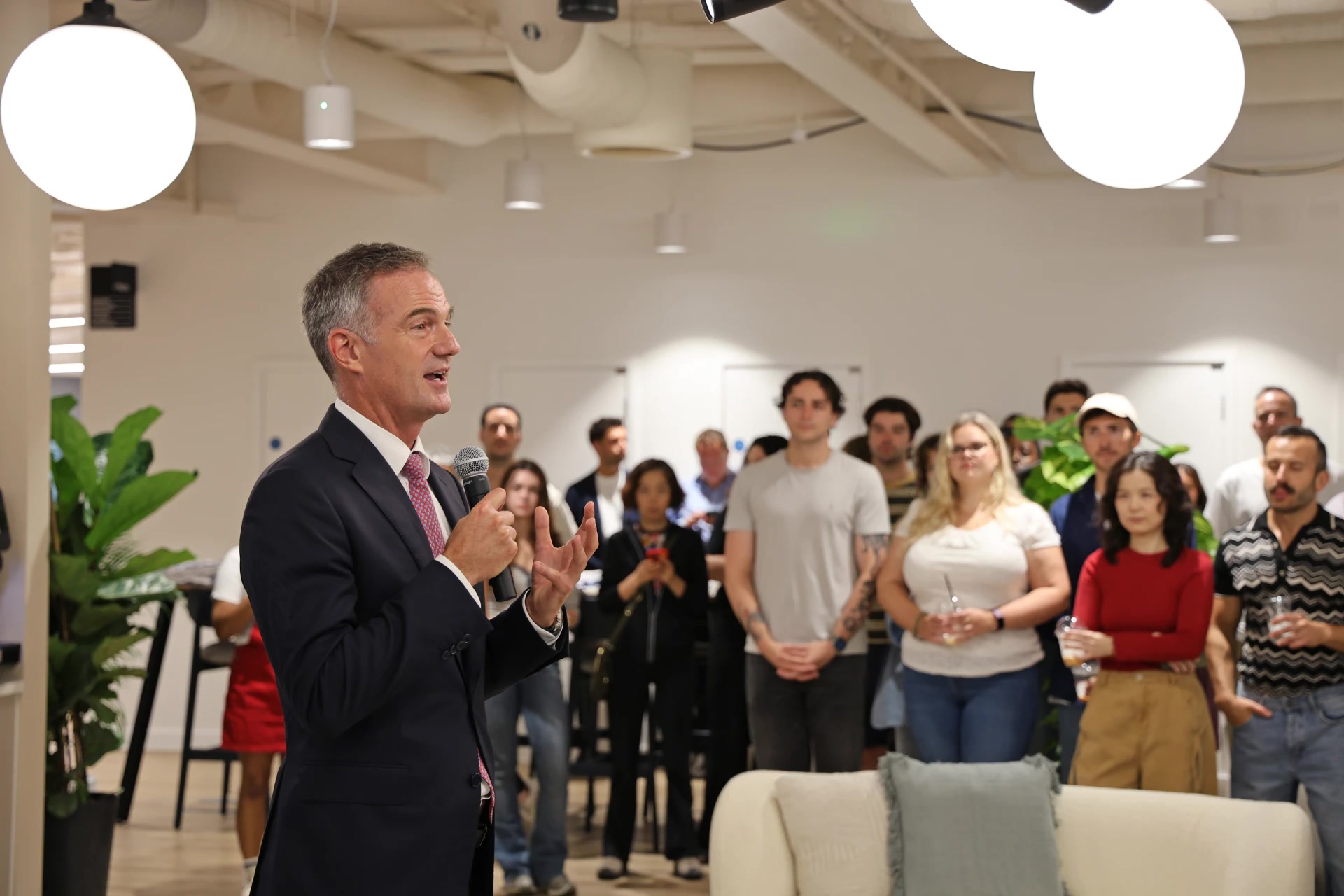 Staff gather while a speaker addresses them inside Synthesia's London headquarters