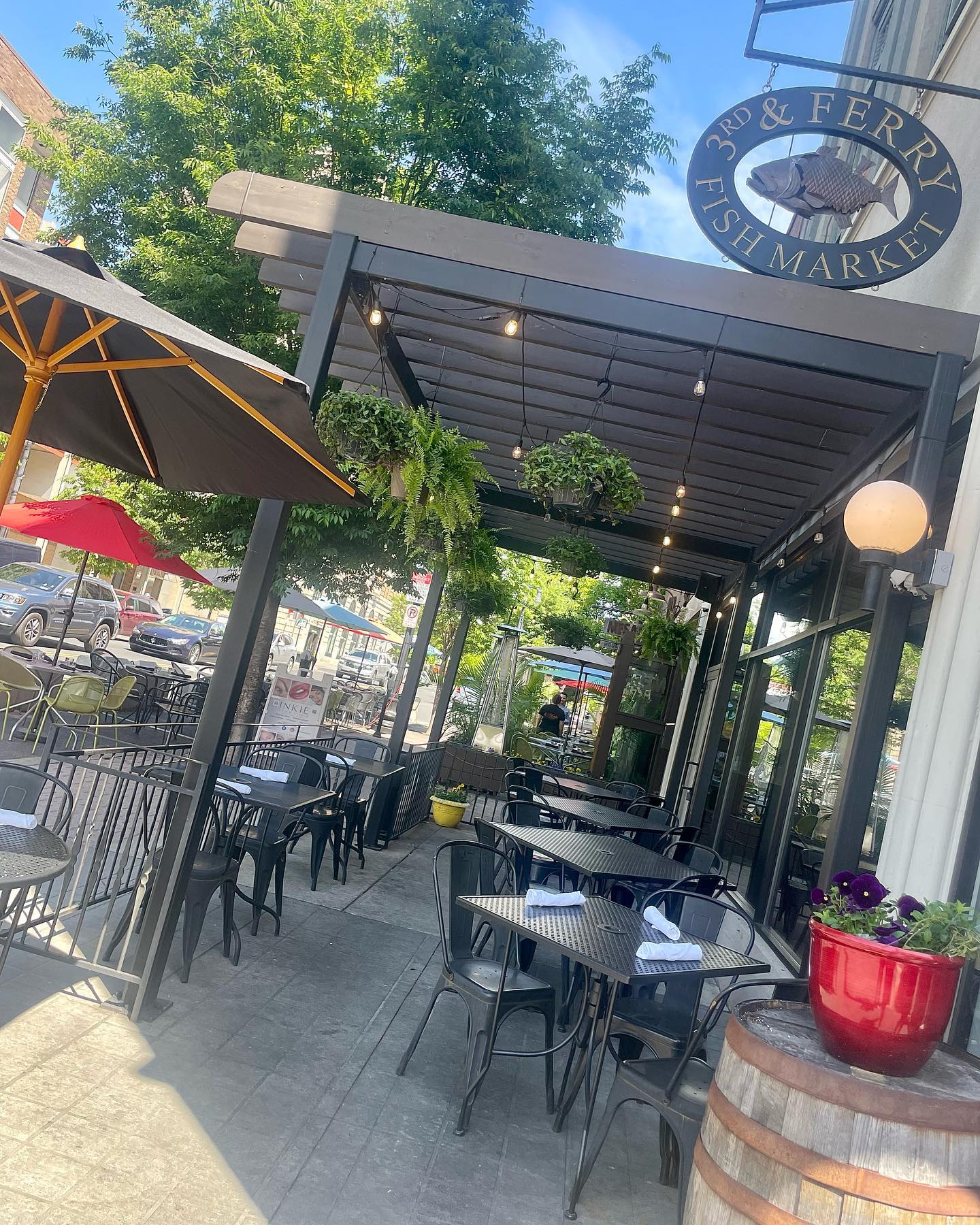 Outdoor tables beneath the 3rd and Ferry Fish Market sign