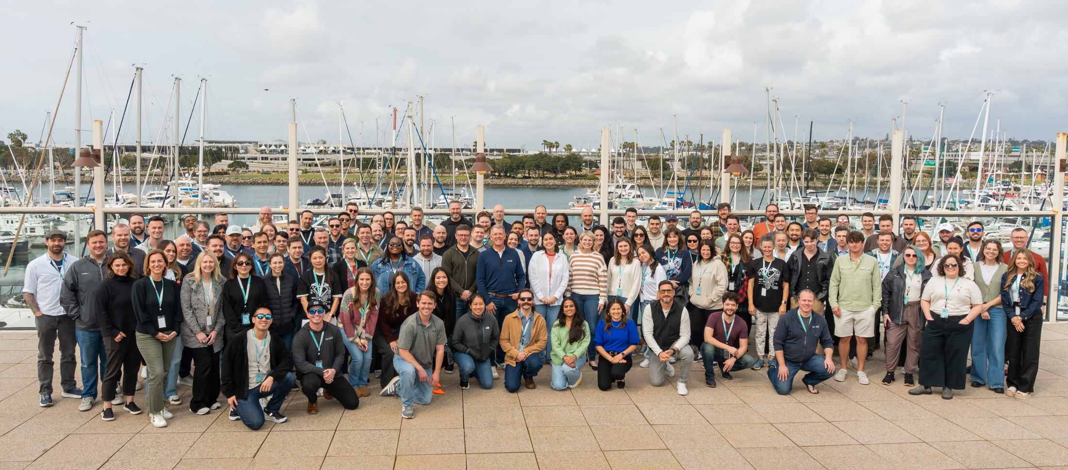 A large Tackle team group gathered beside a marina