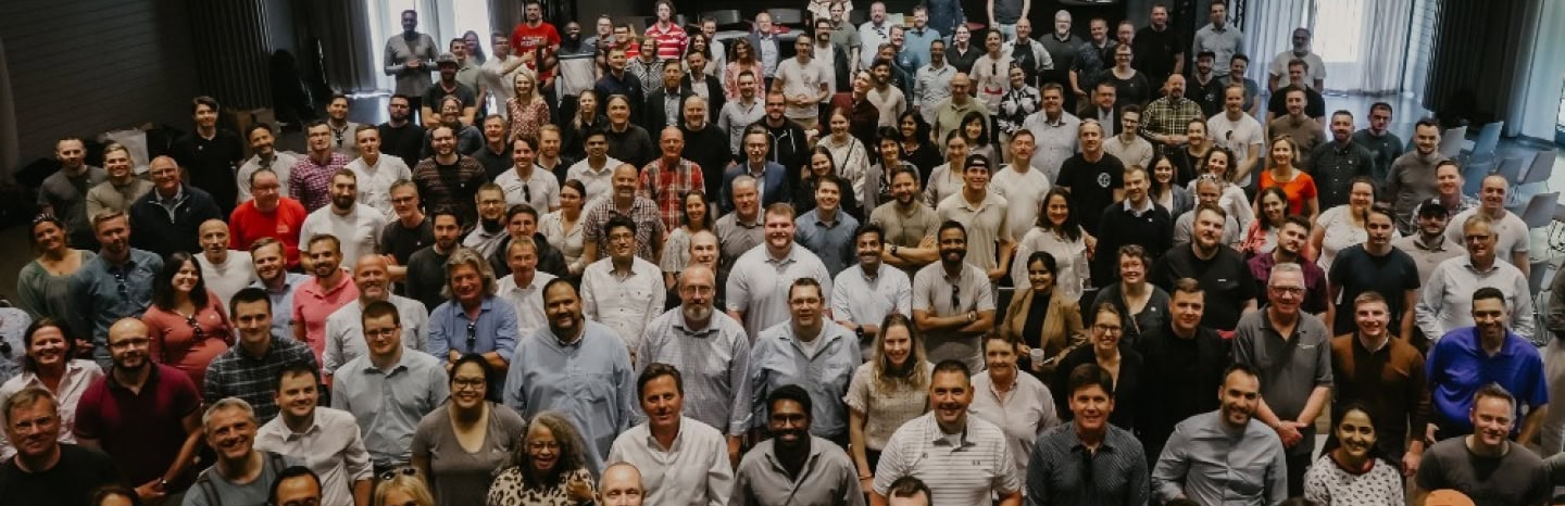 A large group of Tacton employees gathered for a team photograph