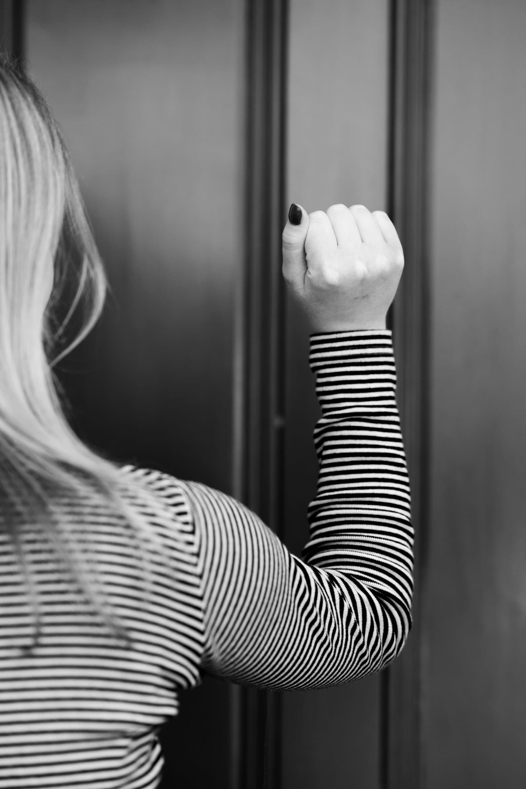 A person knocking on a front door in TAG Strategies voter-contact imagery