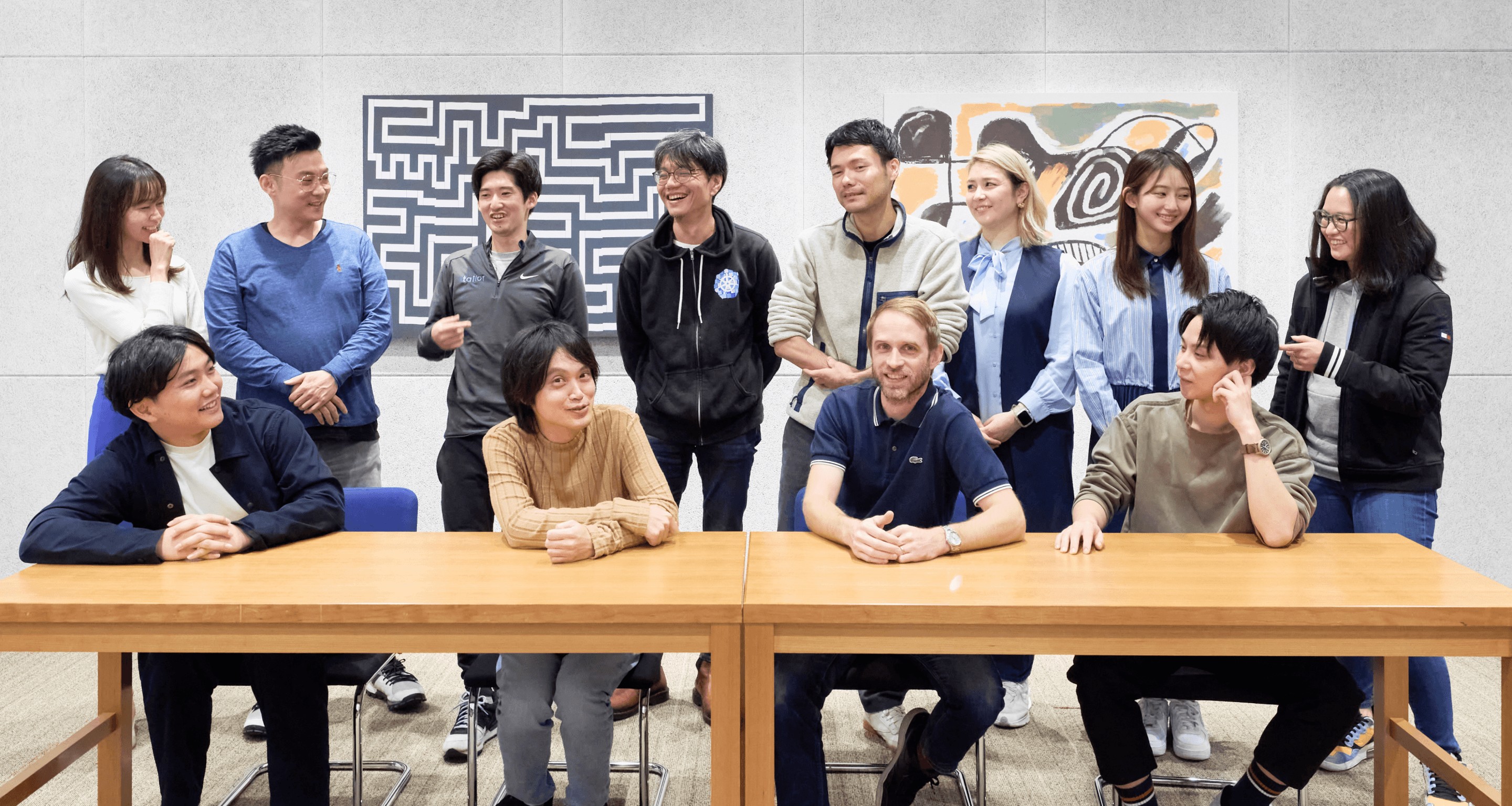 Members of the Tailor team gathered around a table