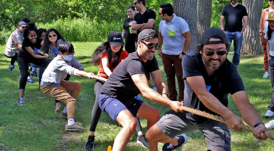 The illumin team taking part in an outdoor tug-of-war