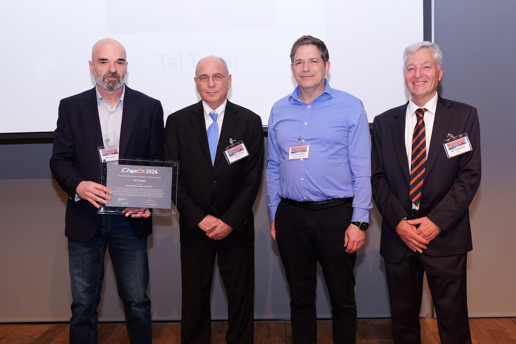 Tal Tamir, at left, holding his ChipEx2026 award alongside three other attendees