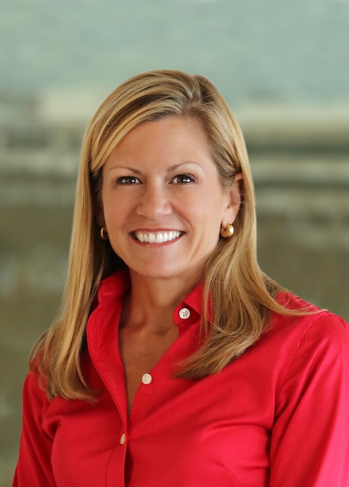 Talbott Roche in a red blouse, in an archival Blackhawk Network press photograph