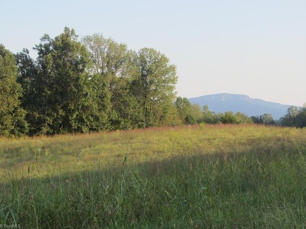 A rural meadow and wooded hills near Lawsonville, North Carolina