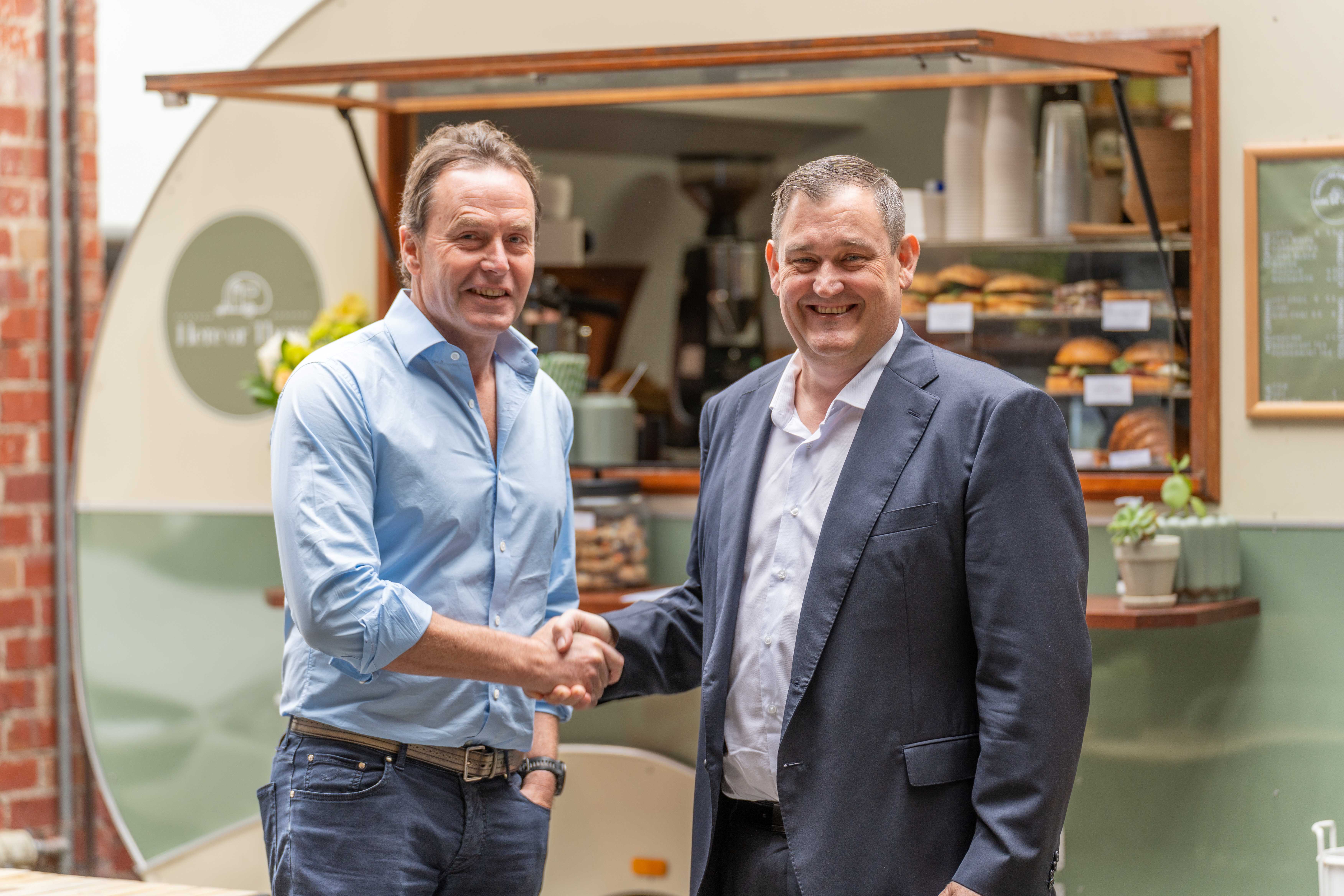 Tally Group CEO Andrew Duncan and Alinta Energy CEO Jeff Dimery shaking hands