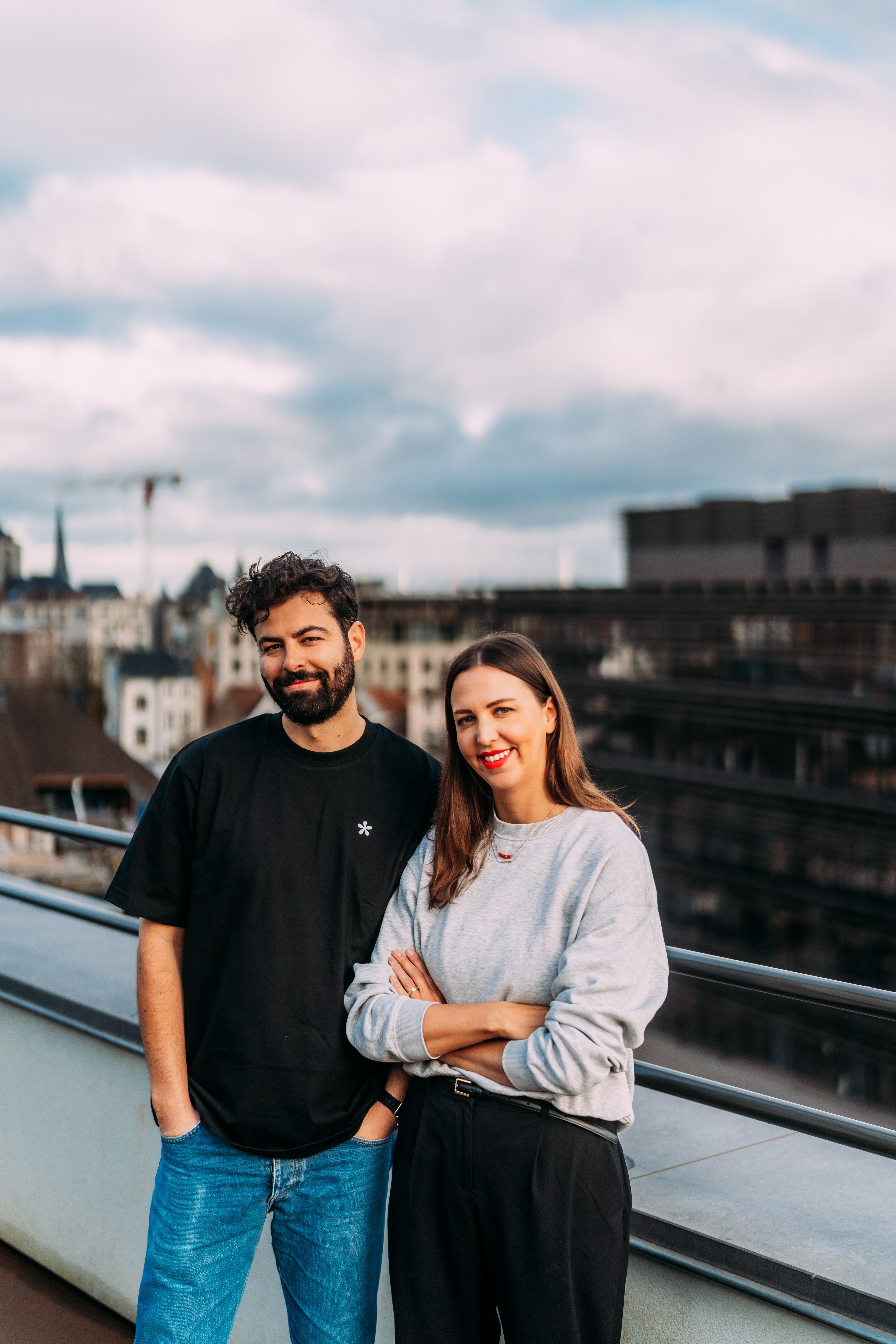 Tally co-founders Filip Minev and Marie Martens standing on a rooftop