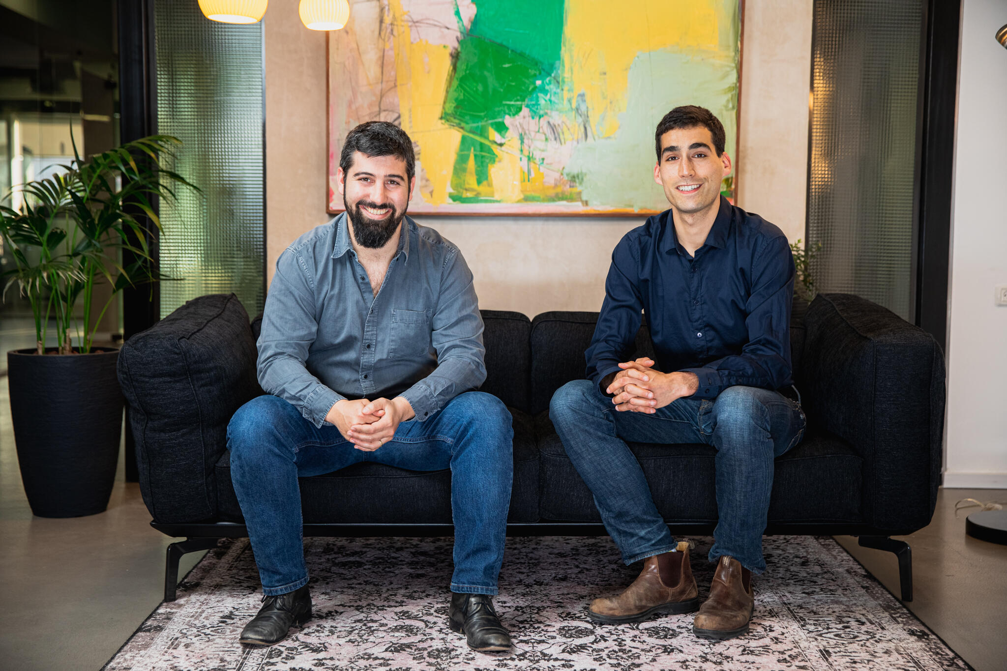 Tamar Bar-Ilan and Yotam Segev seated together in a Cyera office in the company’s early years