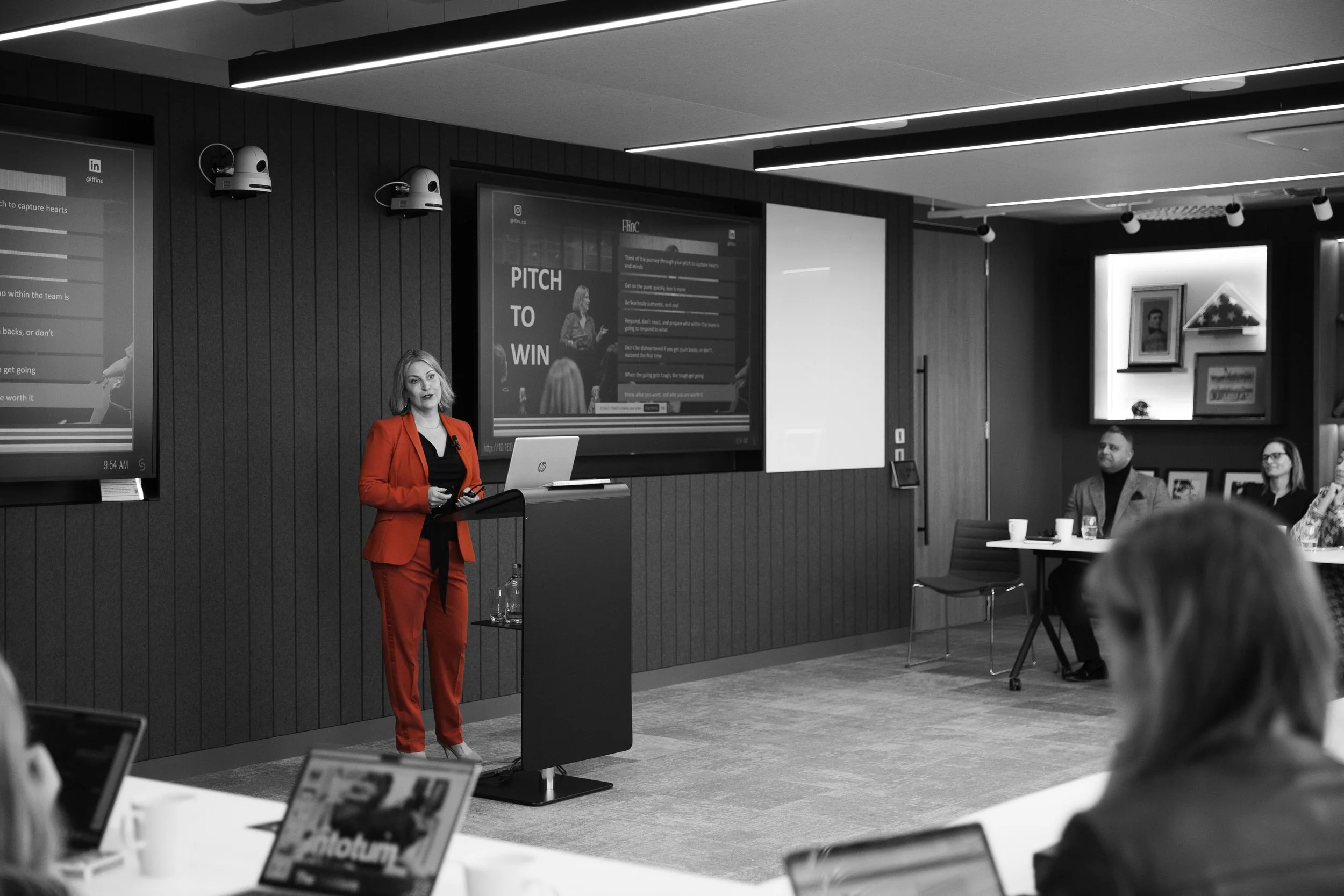 Tamara Gillan in a red suit leading a pitch session at an FFinc accelerator bootcamp