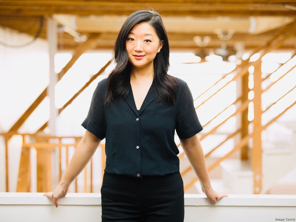 Tammy Sun standing in a bright timber-framed office