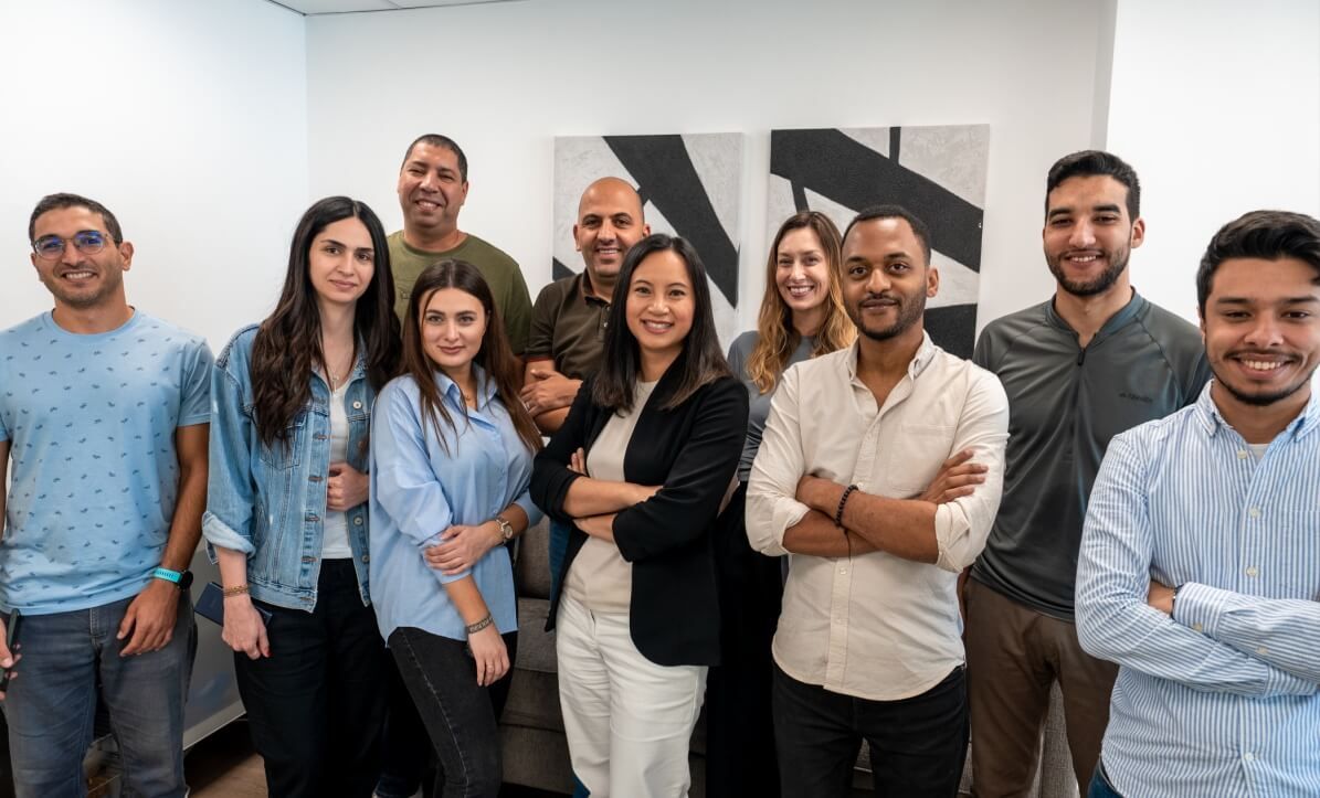 Members of the Journify team gathered together in an office