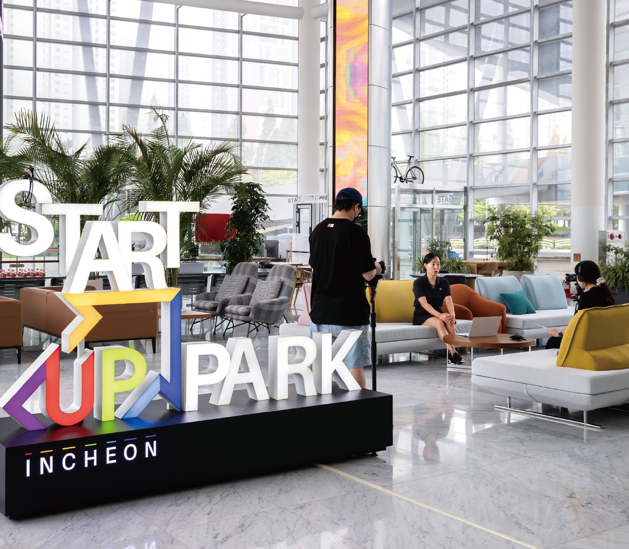 An interview being filmed in the bright atrium of Incheon Startup Park