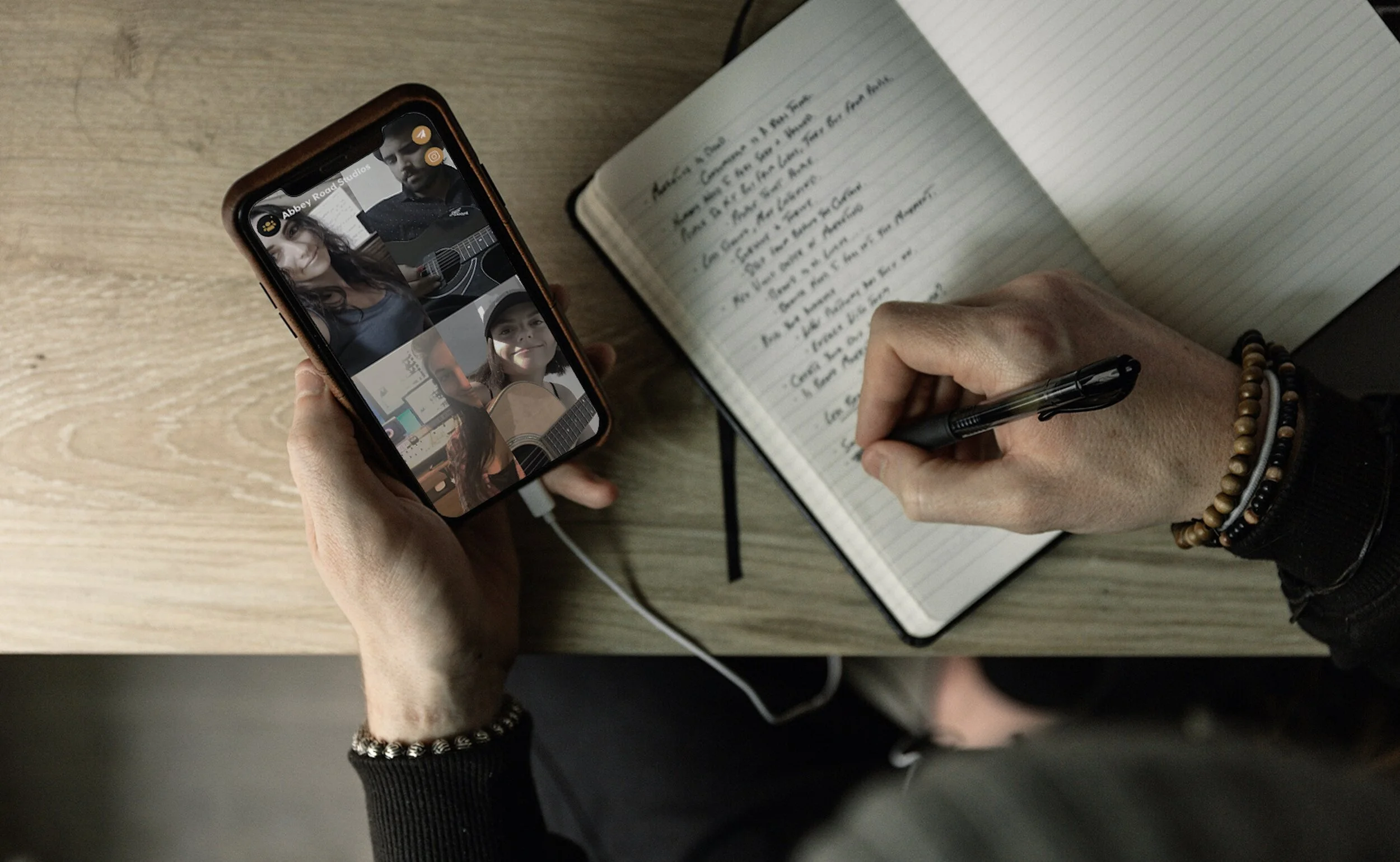 TapRoom promotional photograph of a group video call beside an open notebook
