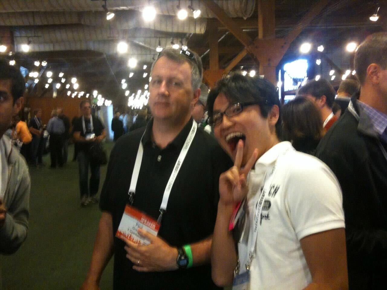 Paul Graham on the left and Taro Fukuyama on the right at a crowded event