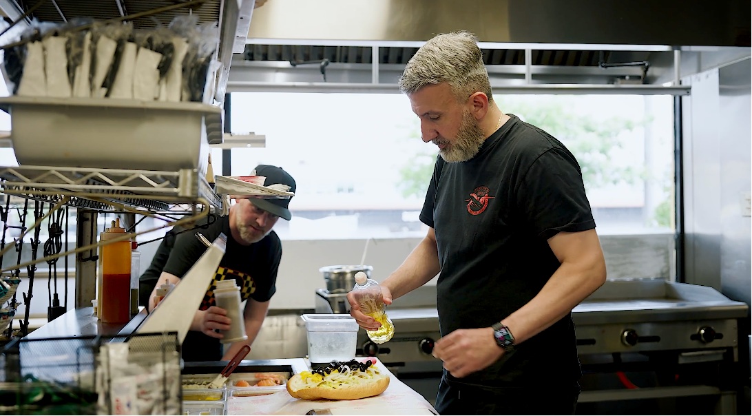 A Pete’s Pizza operator preparing a sandwich in the restaurant kitchen
