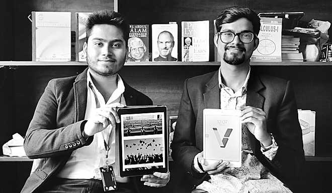 Tarun Gupta, left, and Vevsa co-founder Rajat Dhiman seated in front of bookshelves