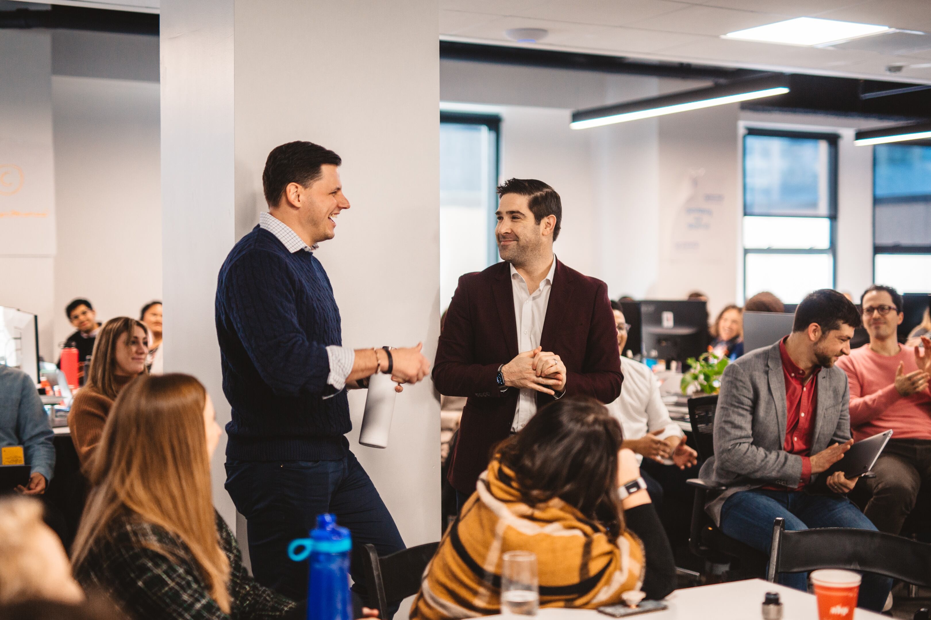 Taylor Justice, left, and Dan Brillman speaking together at a Unite Us team gathering