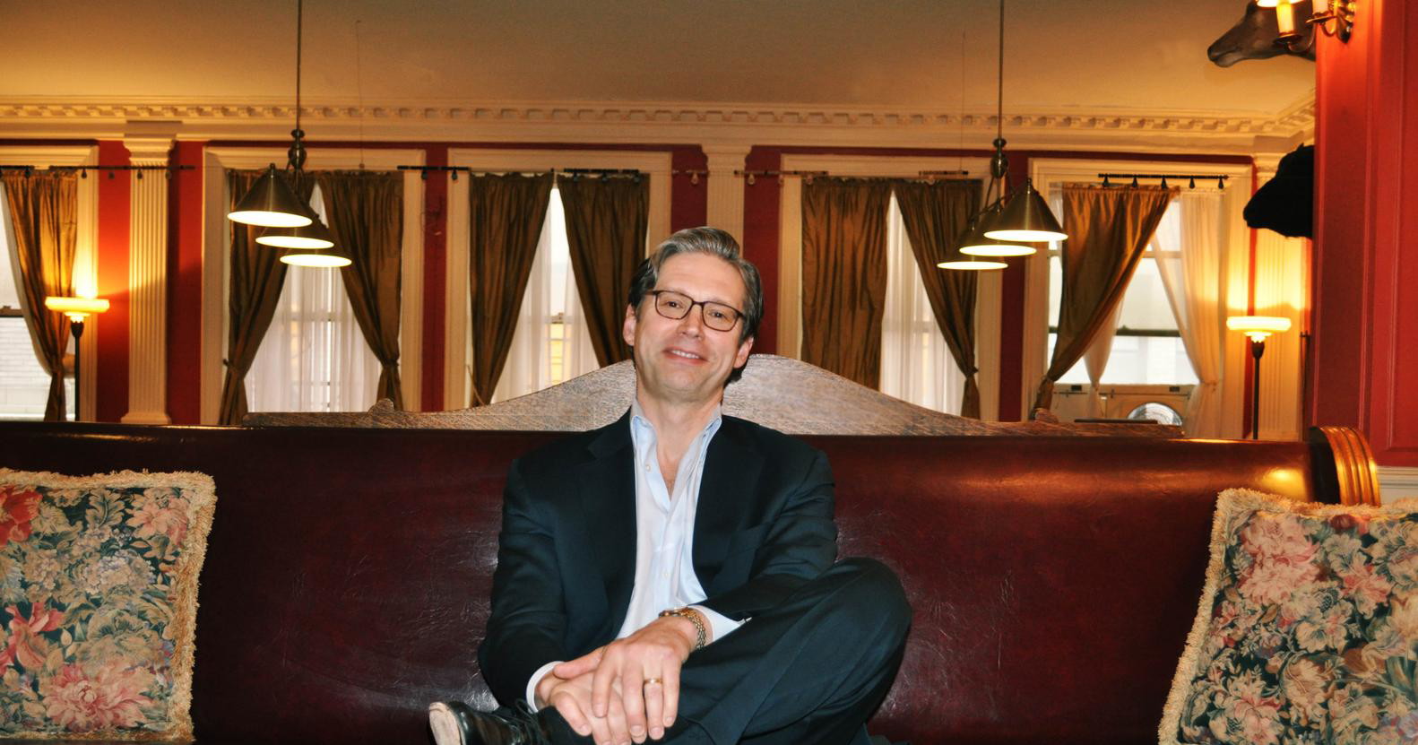 Brian Rafferty seated in a warmly lit room