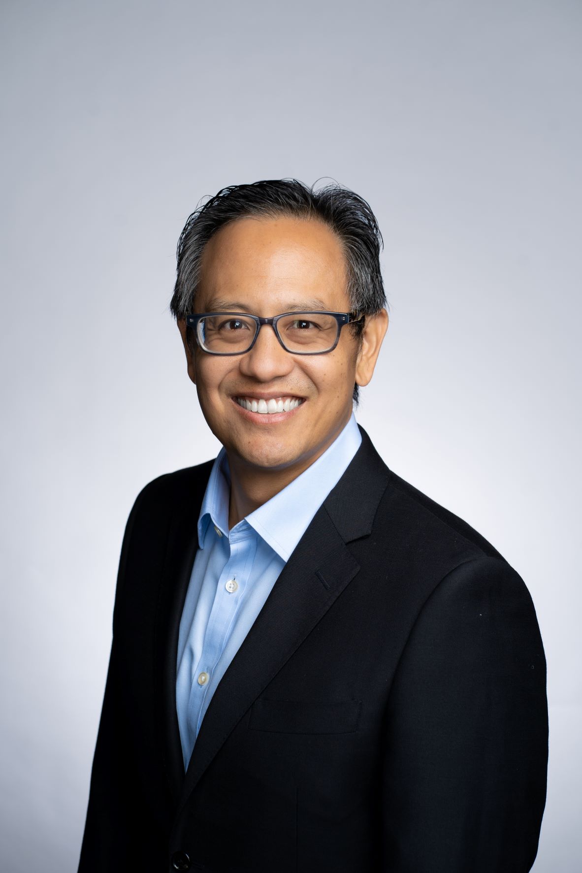 TCGX founder Chen Yu in a dark jacket and open-collar shirt