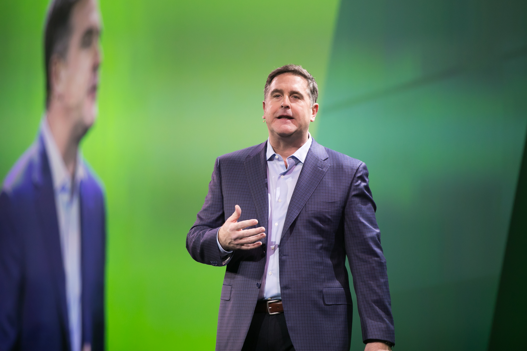 TD Ameritrade Institutional president Tom Nally speaking on a green-lit conference stage