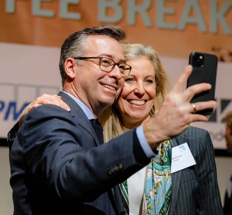 Two attendees taking a selfie at a Tech Nordic Advocates event