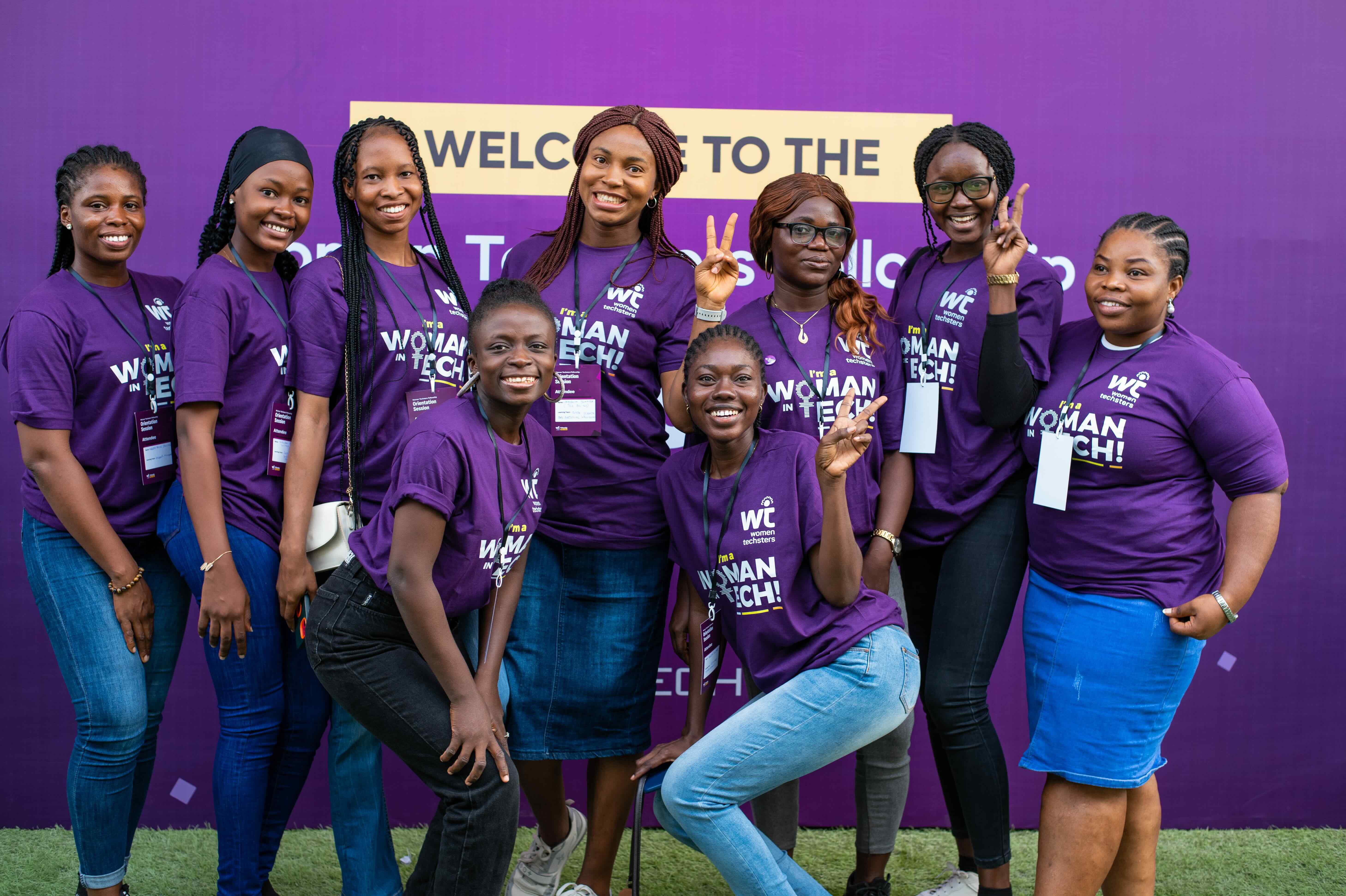 Women Techsters community members wearing purple shirts at a gathering