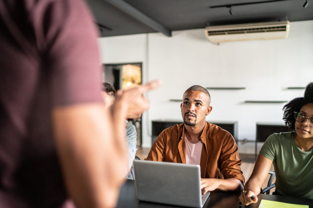 People gathered around a table in a TechAlliance office setting
