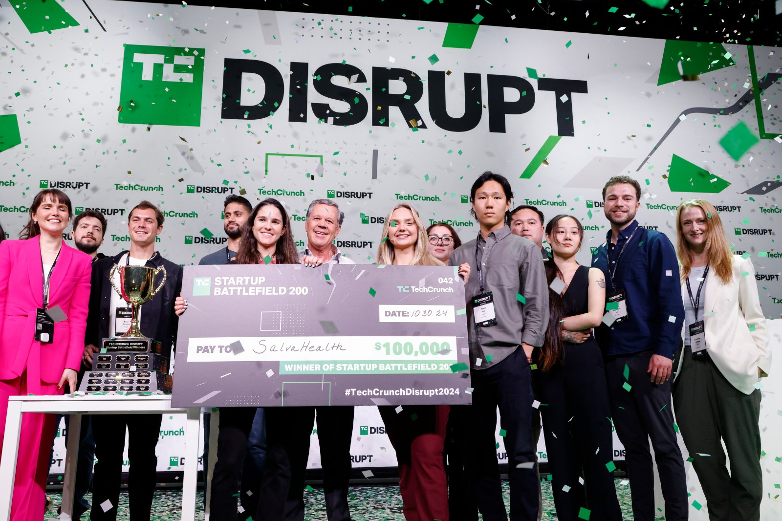 Startup Battlefield participants celebrate with a trophy and a $100,000 check for SalvaHealth at Disrupt 2024