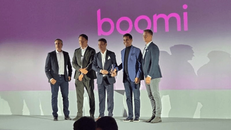 Five people on a Boomi-branded award stage